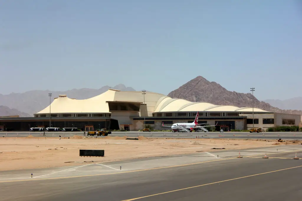 Passenger aircraft parked at Sharm El Sheikh International Airport (SSH / HESH) terminal with desert mountain backdrop in Sharm El Sheikh, Egypt. Sharm El Sheikh International Airport (SSH / HESH) Private Jet Charter